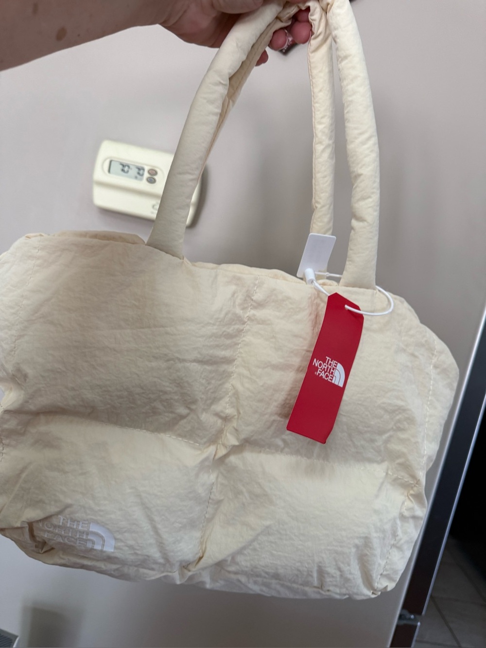 The North Face Cream Quilted Puffer Tote with Red Tag